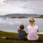 Mommy and son photo facing the shore and nature.